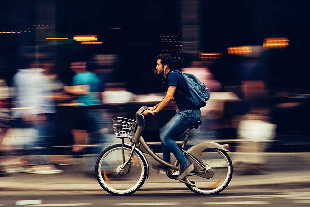 Person riding bicycle through city 