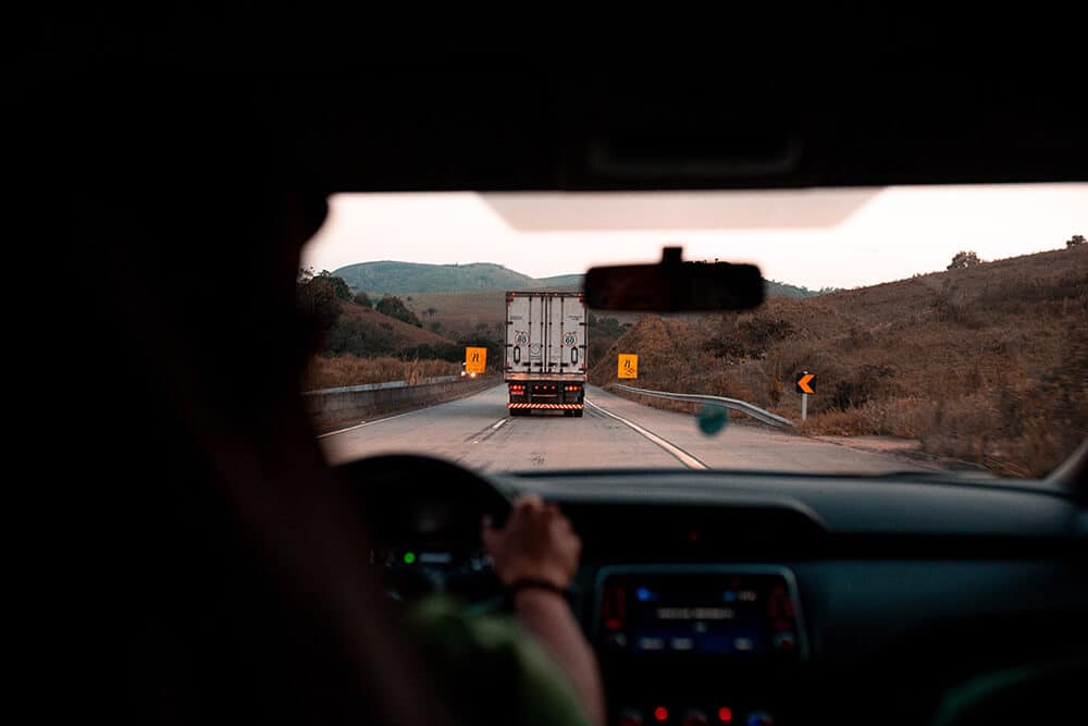 Trucker on road with truck ahead of them